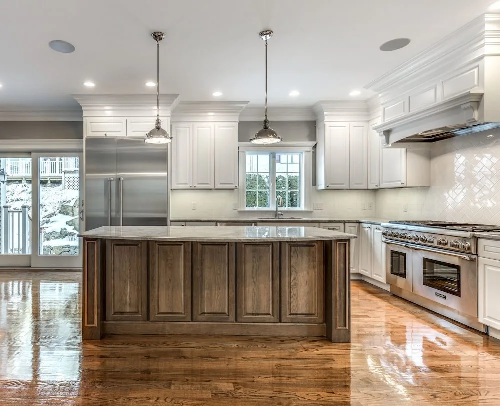 Open-concept kitchen with hardwood floors, large center island, and professional-grade range