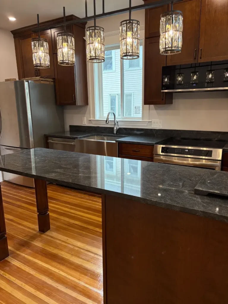 Modern kitchen with dark wood cabinets and black granite countertops