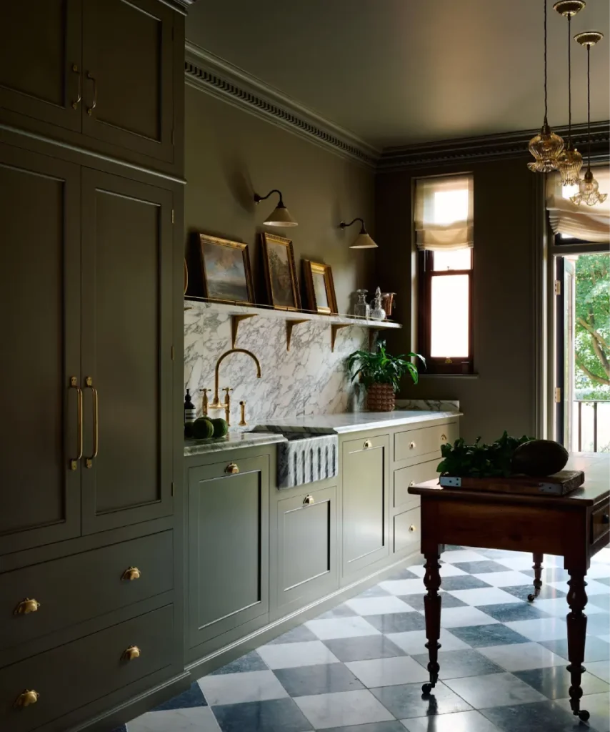 Wilmington kitchen with farmhouse sink, marble counters, and brass fixtures