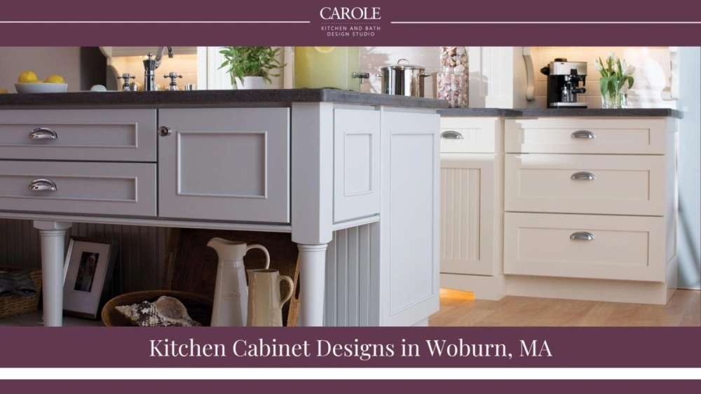 Elegant white kitchen cabinets with dark countertops in Woburn home.